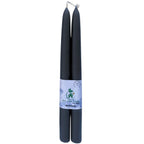 Tall black beeswax taper candles used as natural, eco-friendly centrepieces for a wedding reception table.