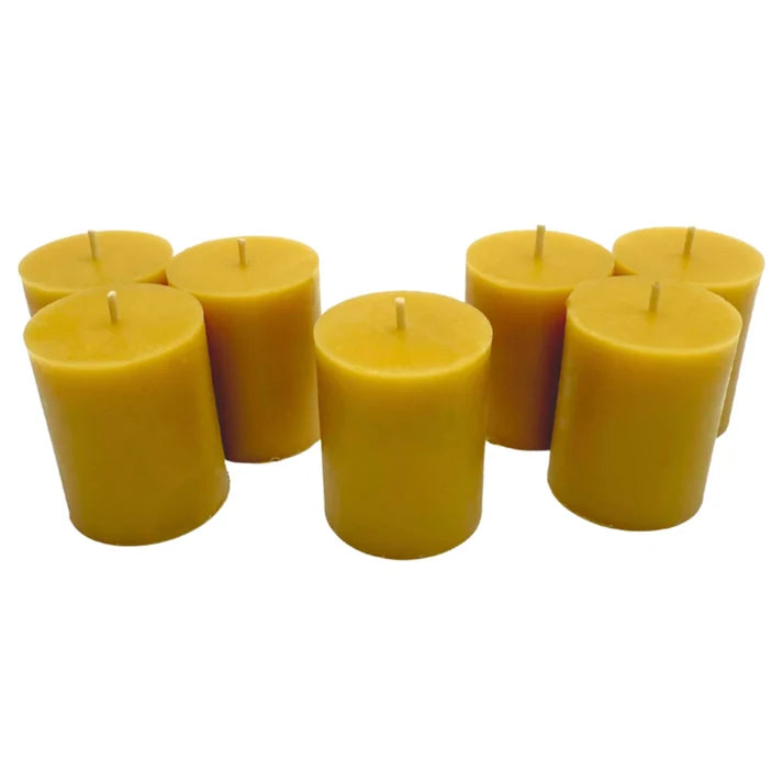 Wholesale pure British beeswax votive candles in multiple colours arranged for B2B retail ordering